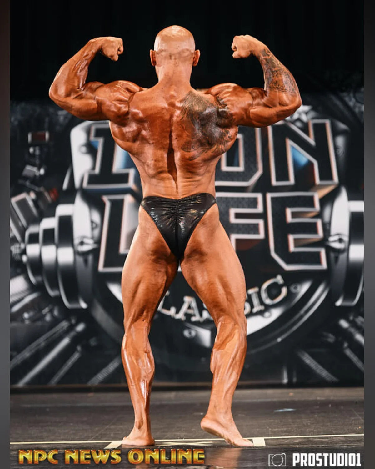 Custom bodybuilding trunks black mist hologram back view, Rio cut with gather, made-to-order NPC and IFBB stage-legal