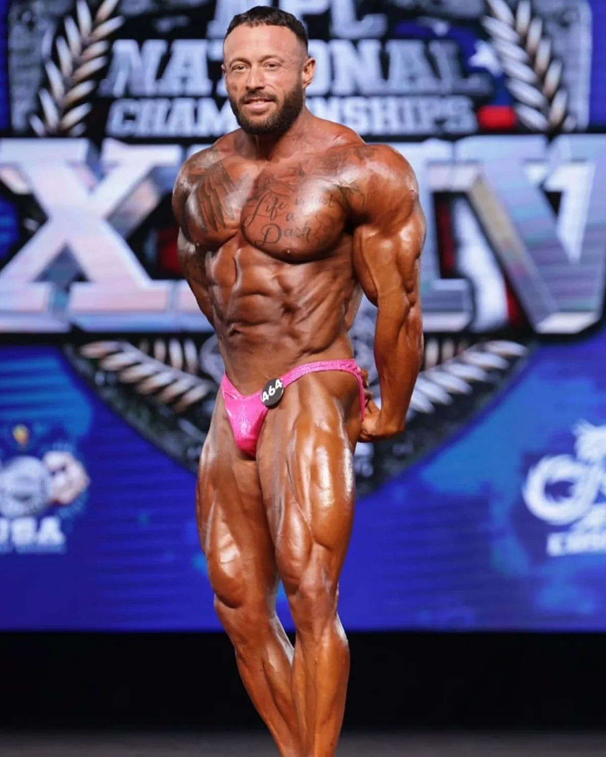 Custom bodybuilding trunks hot pink shatterglass, Rio cut with gather, side view of made-to-order NPC and IFBB trunks
