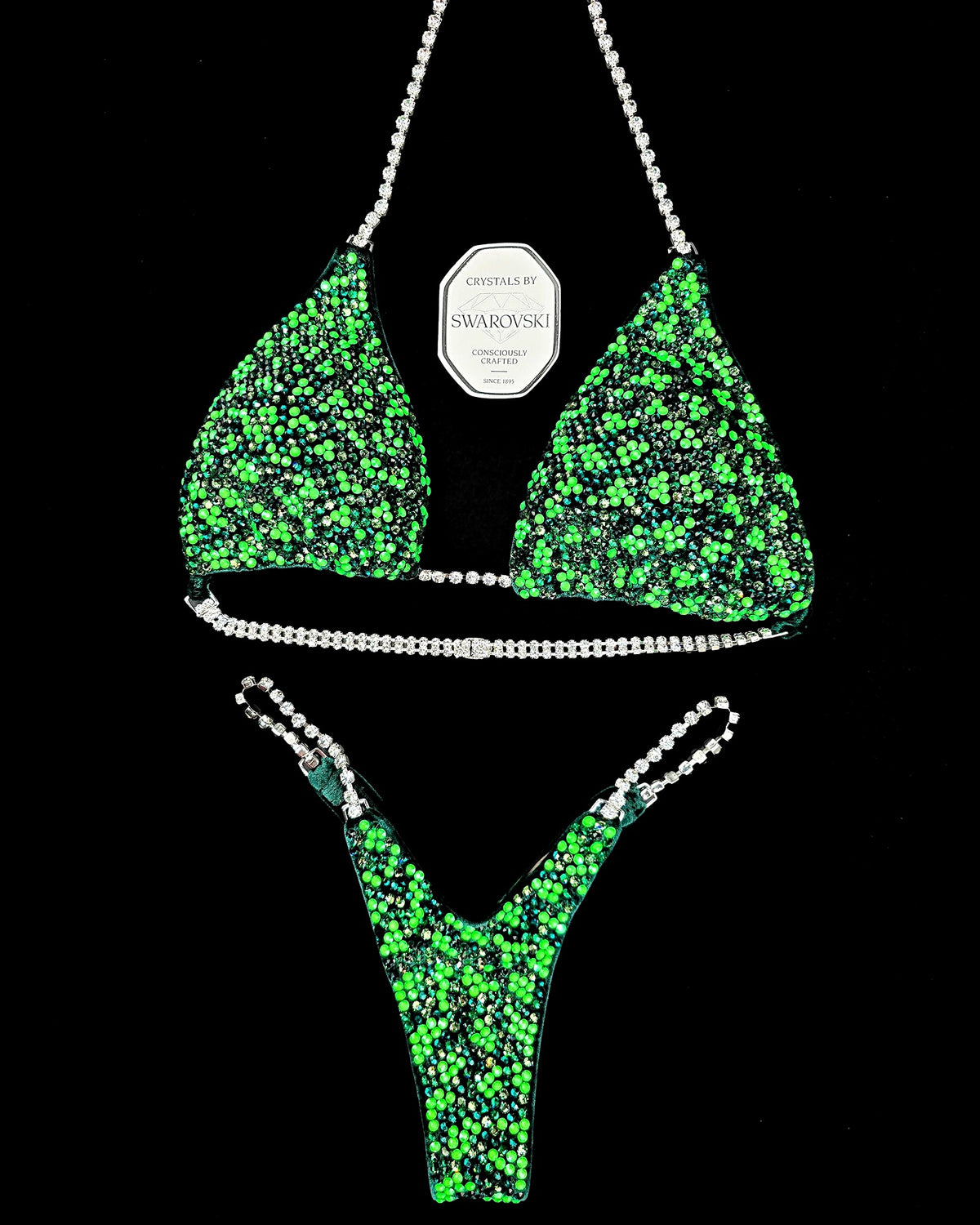 Maureen Blanquisco 2026 Olympia competition bikini flat lay, covered in green Swarovski crystals with crystal chain straps