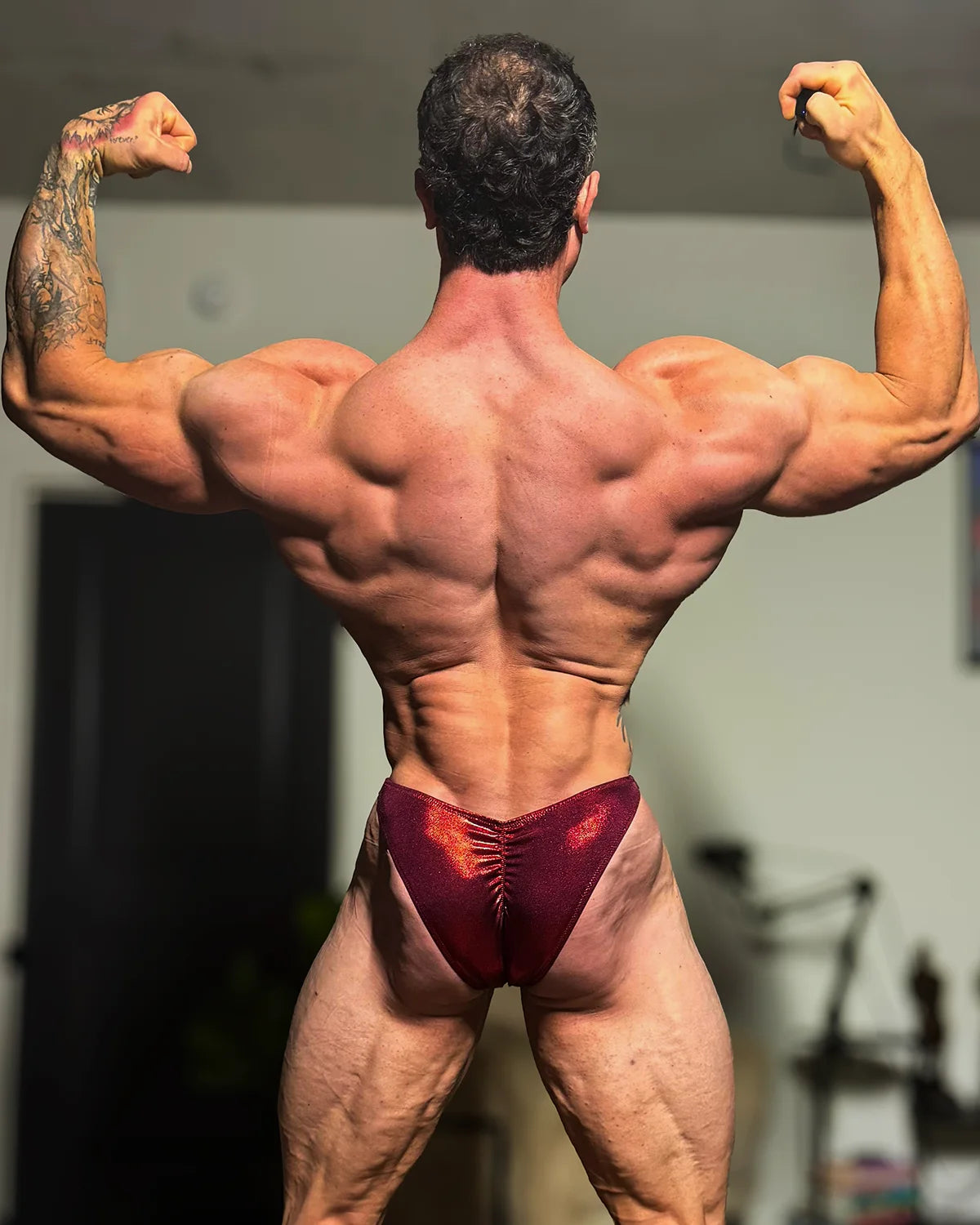 Mist hologram bodybuilding trunks in burgundy as worn by IFBB Pro Conner Kovacs, back view