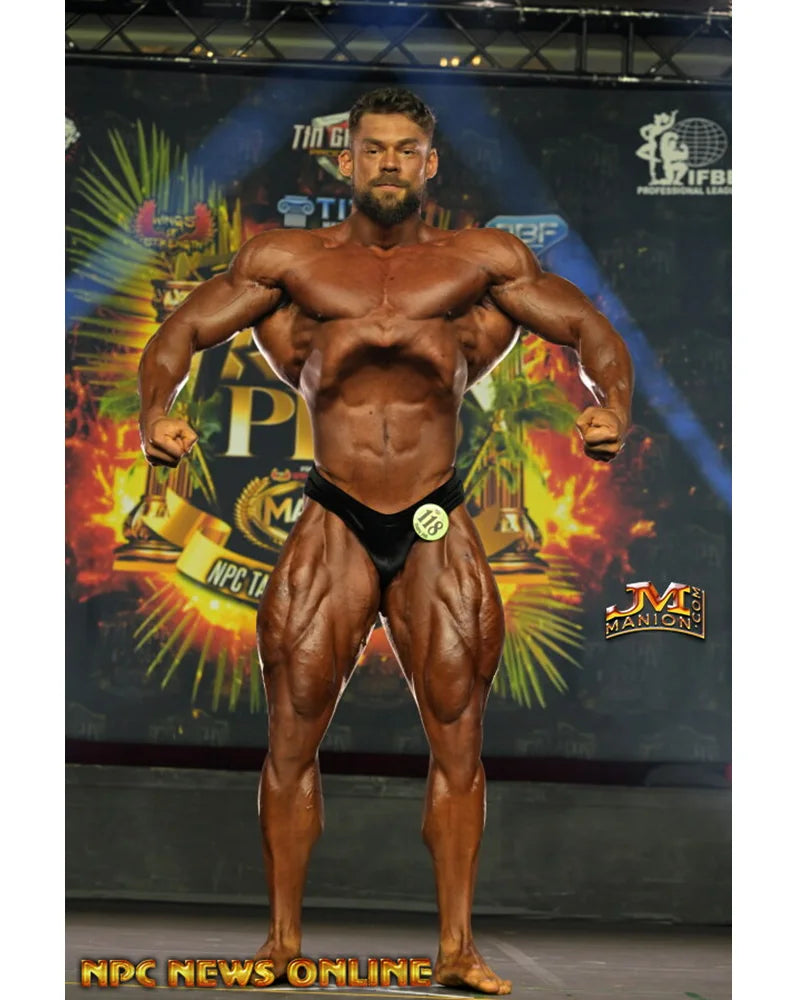 Velvet PRO Cut classic physique trunks worn on stage, rich texture catches stage light softly between matte and hologram