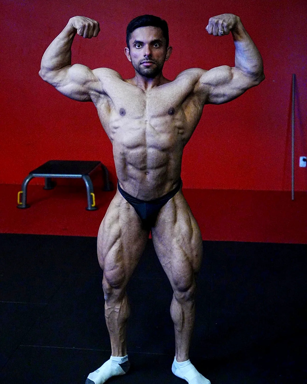 Bodybuilding trunks, custom Ratan, front double biceps pose. Made in America.