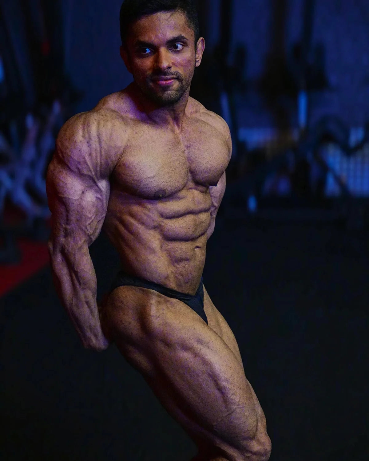 Bodybuilding trunks, custom Ratan, side chest pose. Made in America.