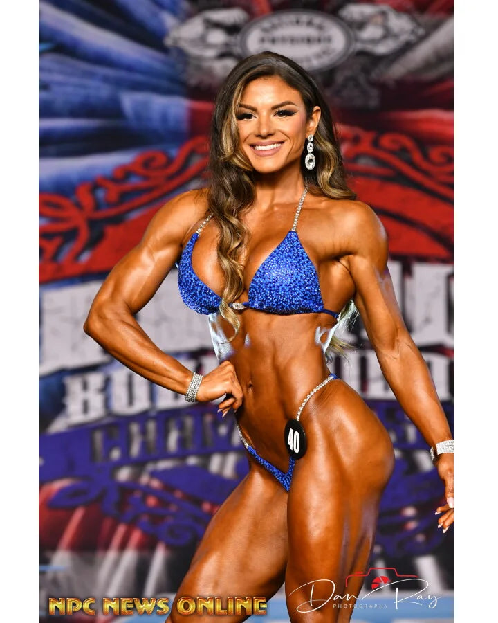 Electric blue NPC bikini with Swarovski crystal front placement, high-cut silhouette, competition ready